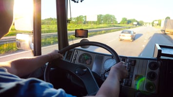 A truck following a car too closely on an interstate