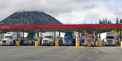 Trucks getting fuel at a fuel island